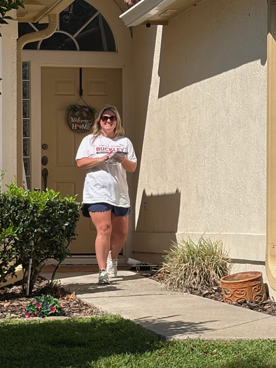 A Team Emily volunteer at a voter's door